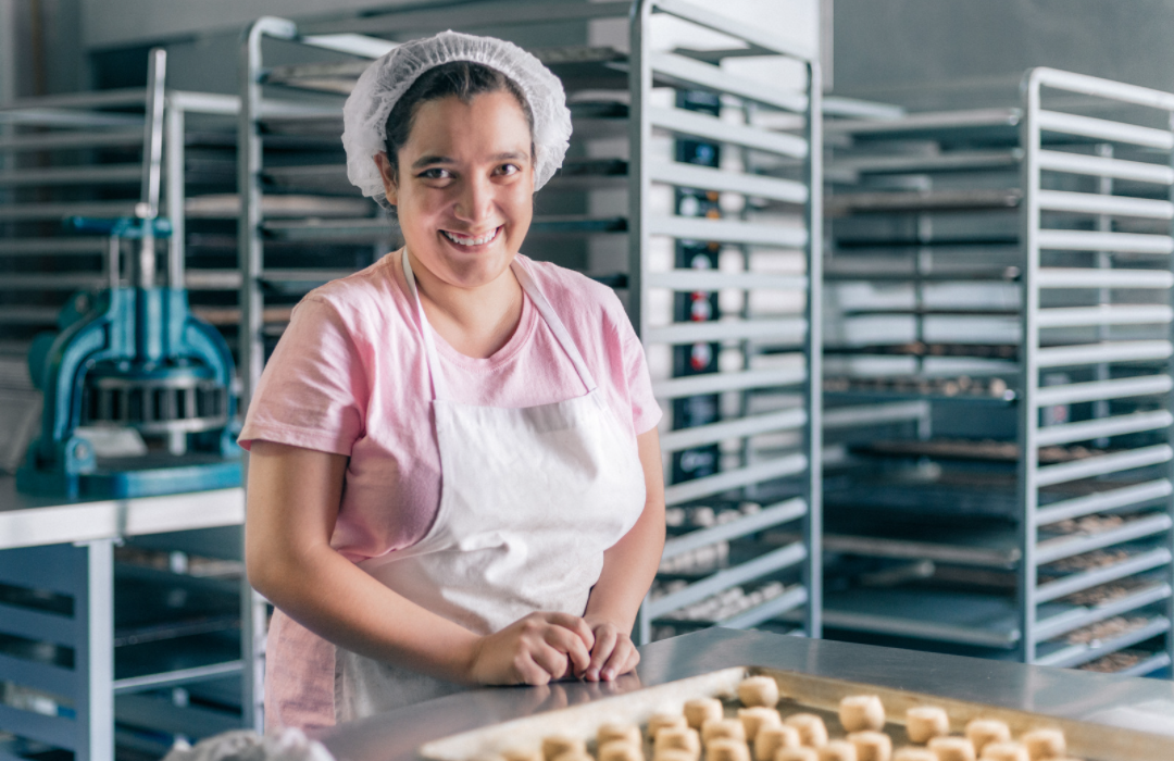 Person with intellectual disability working at a bakery.png